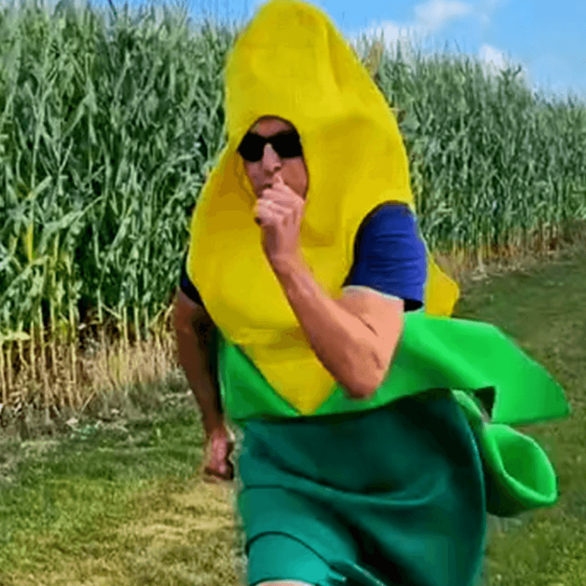 Corn cob costume running in a field
